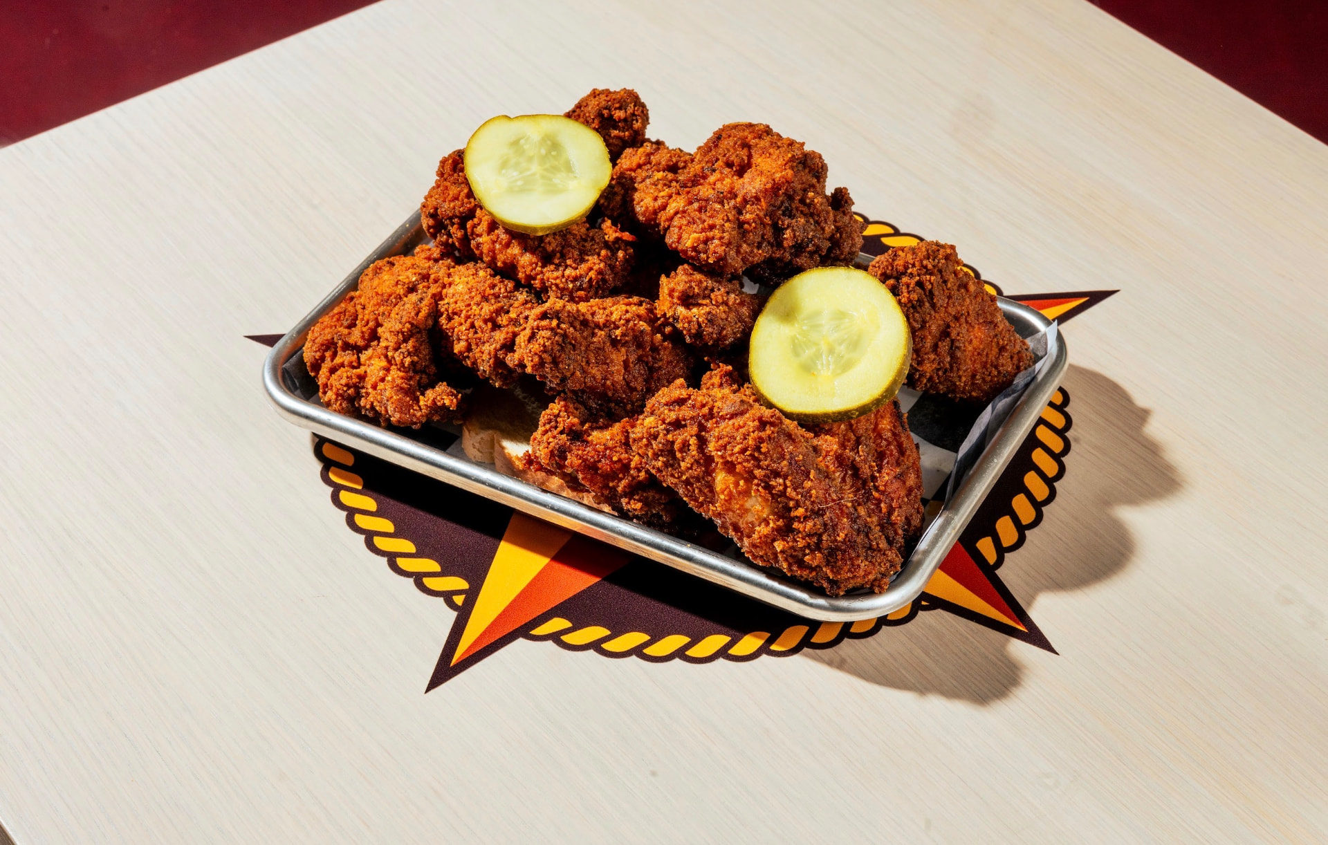 Tray of hot chicken tenders with pickles