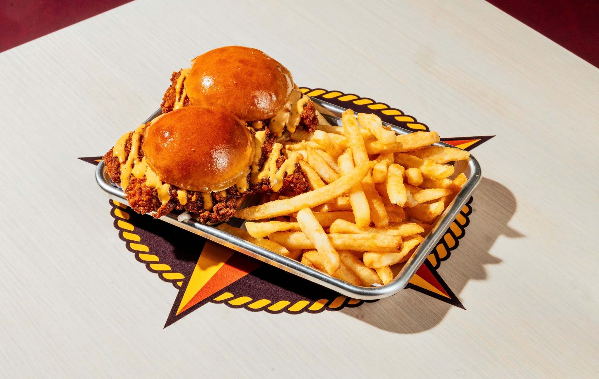 Two chicken sliders with fries on a Hotbirds star