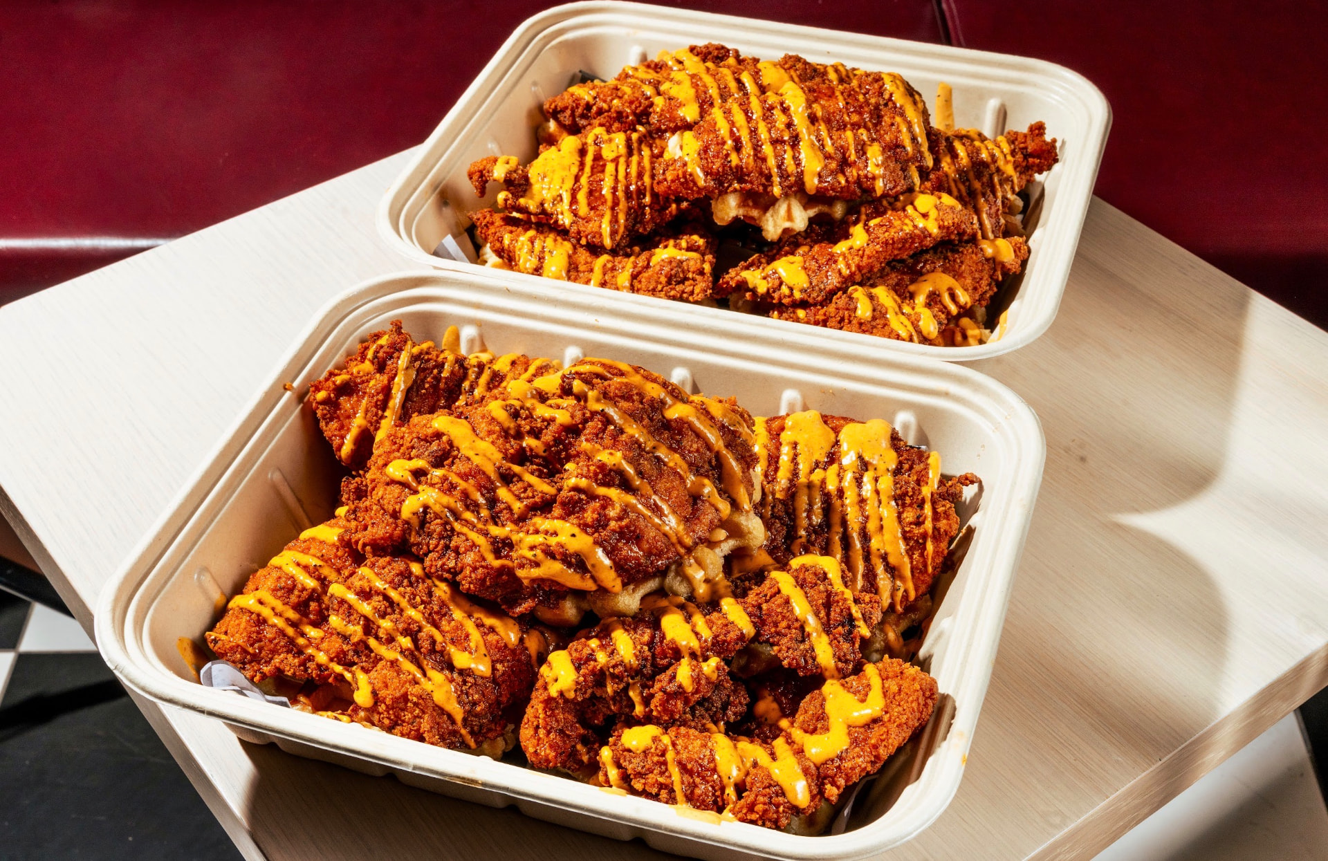 Chicken and waffles drizzled with hot honey sauce